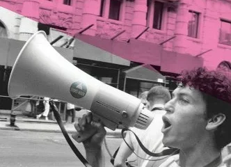 Pink cover with a black and white picture of a young man with a bullhorn. Title across the top