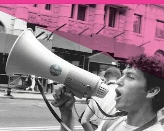 Pink cover with a black and white picture of a young man with a bullhorn. Title across the top